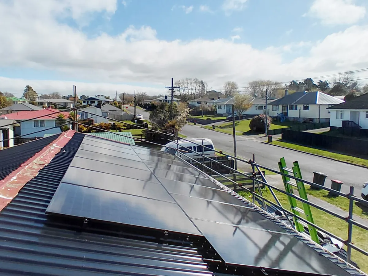 A 6.8kW EFS Solar array on a charcoal metal roof in Stratford, Taranaki, on a suburban street