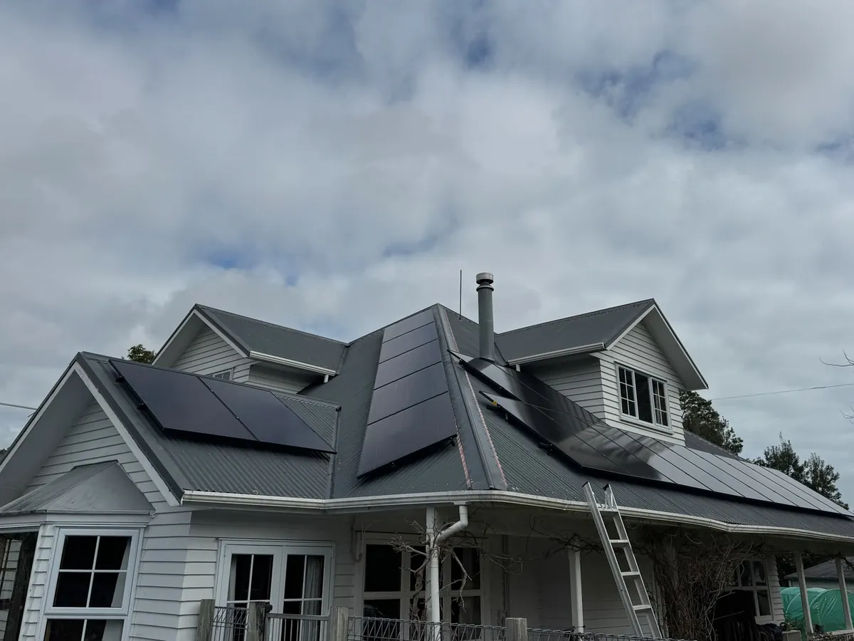 An 8.19kW EFS Solar array on the charcoal roof of a weatherboard villa at Tongapōrutu, Taranaki